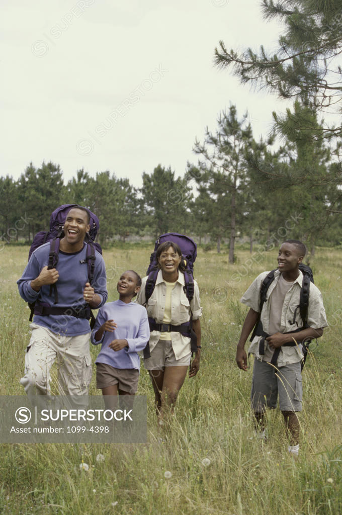 Stock Photo: 1099-4398 Couple and their children hiking in the woods