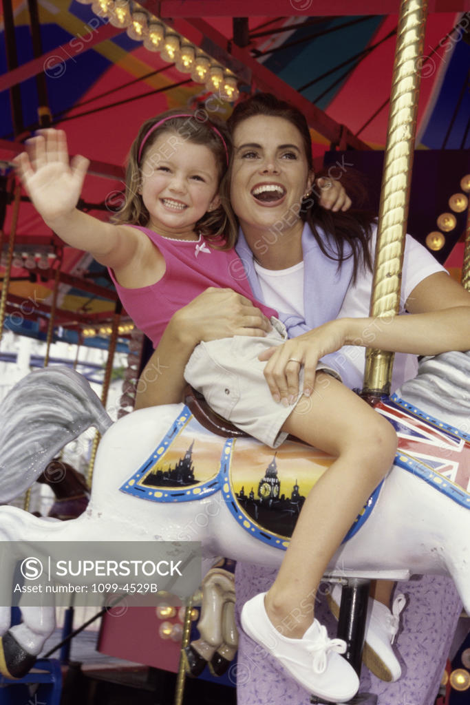 Stock Photo: 1099-4529B Mother and her daughter on a carousel