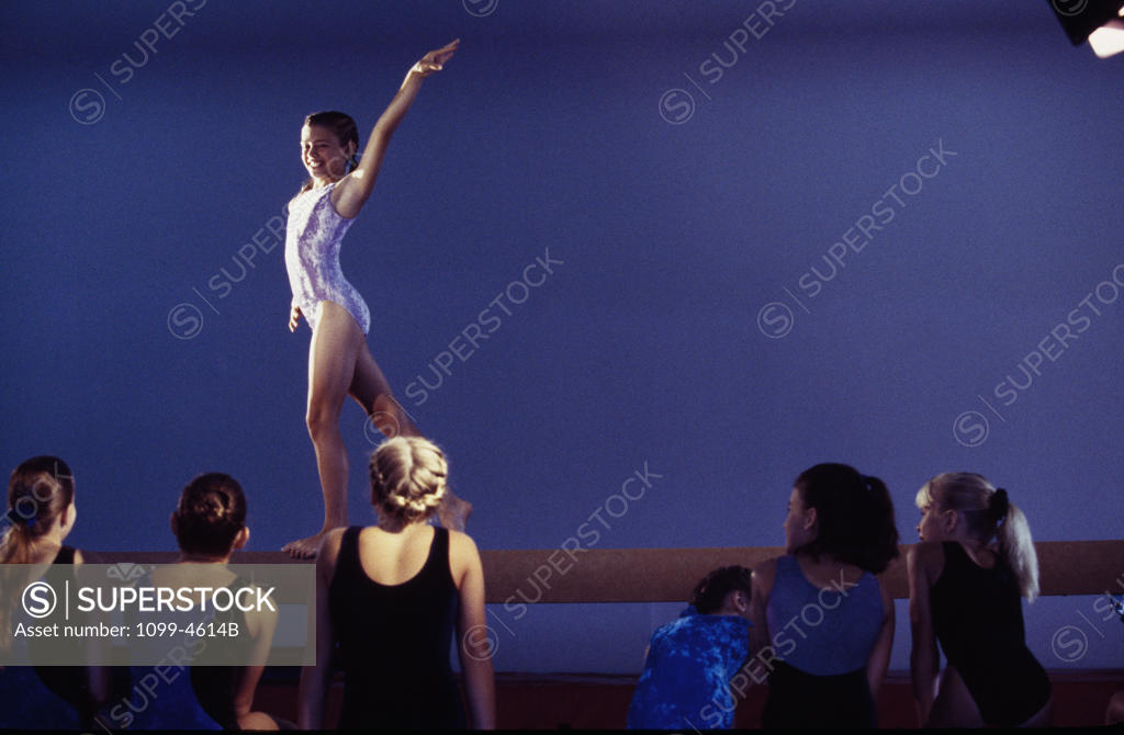 Stock Photo: 1099-4614B Female gymnast performing on a balance beam