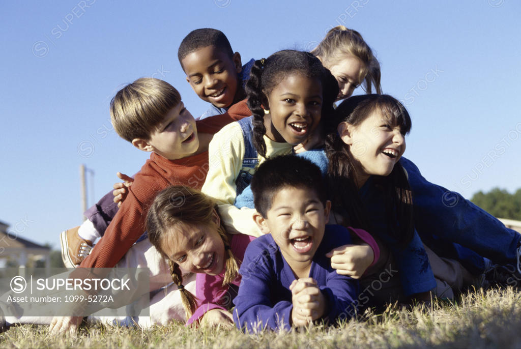 Stock Photo: 1099-5272A Group of children playing on a lawn