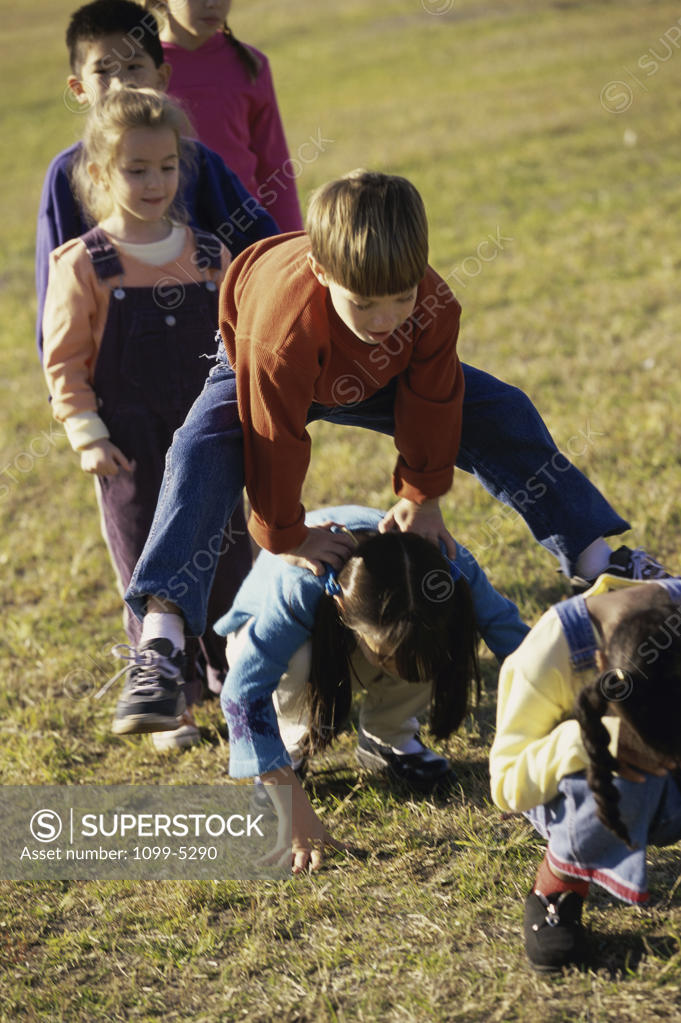 Stock Photo: 1099-5290 Group of children playing on a lawn