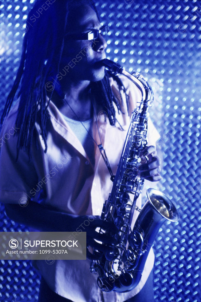 Stock Photo: 1099-5307A Young man playing the saxophone