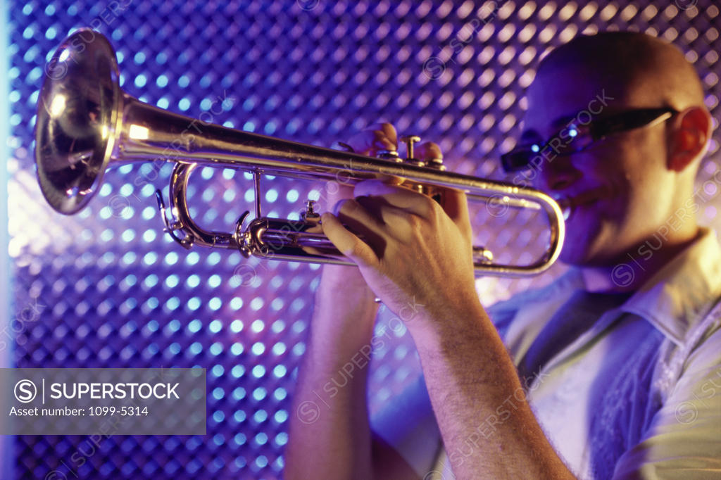 Stock Photo: 1099-5314 Side profile of a young man playing the trumpet