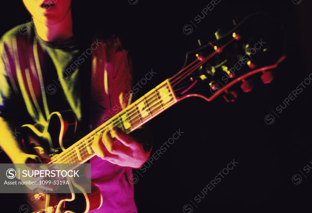 Stock Photo: 1099-5319A Young man playing an electric guitar