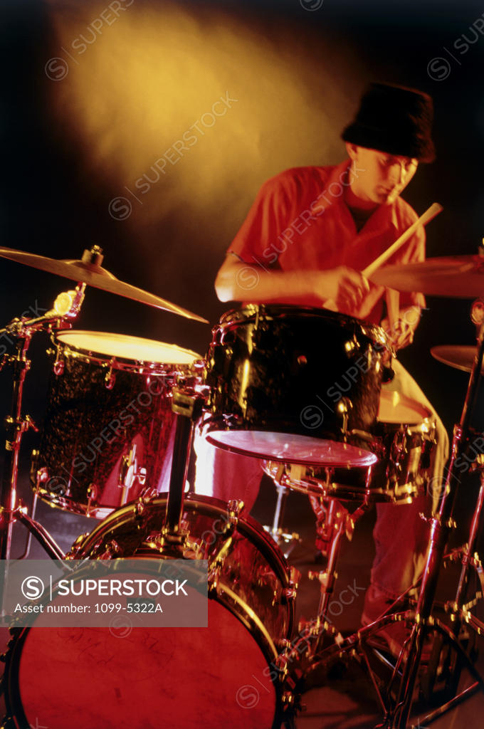 Stock Photo: 1099-5322A Male drummer playing drums