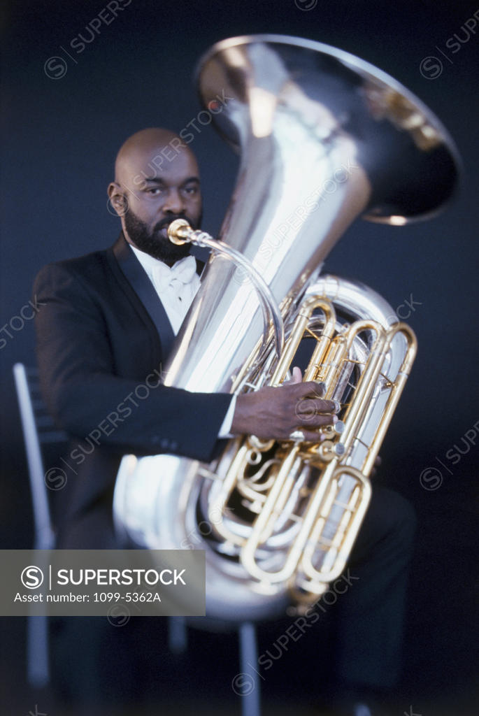 Stock Photo: 1099-5362A Portrait of a mid adult man playing a tuba