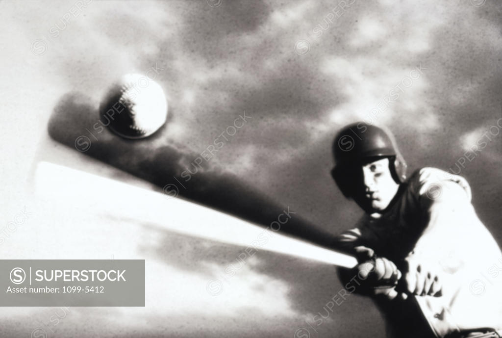 Stock Photo: 1099-5412 Low angle view of a baseball player swinging a baseball bat