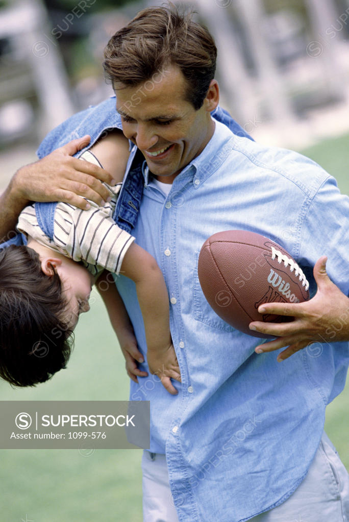 Stock Photo: 1099-576 Father carrying his daughter on his shoulders