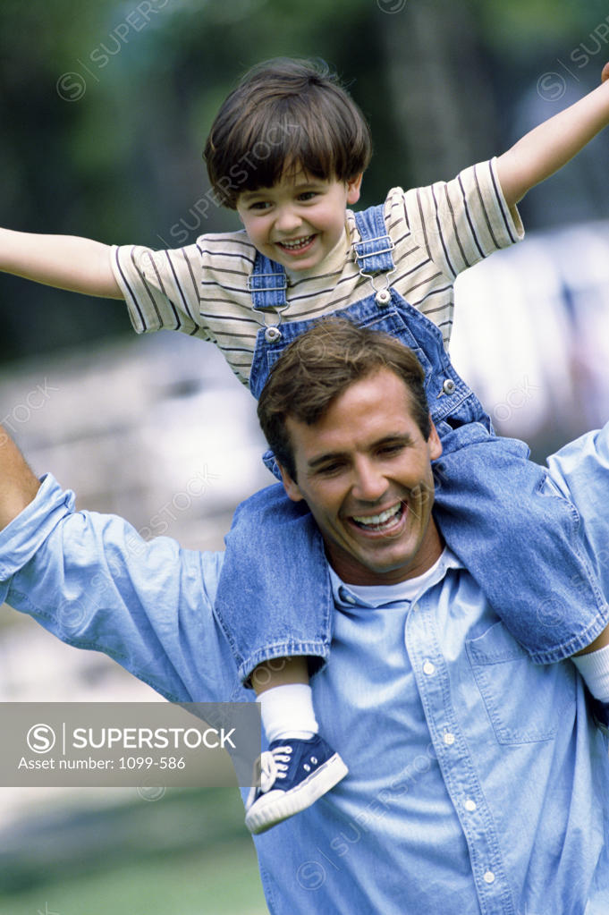 Stock Photo: 1099-586 Father carrying his son on his shoulders
