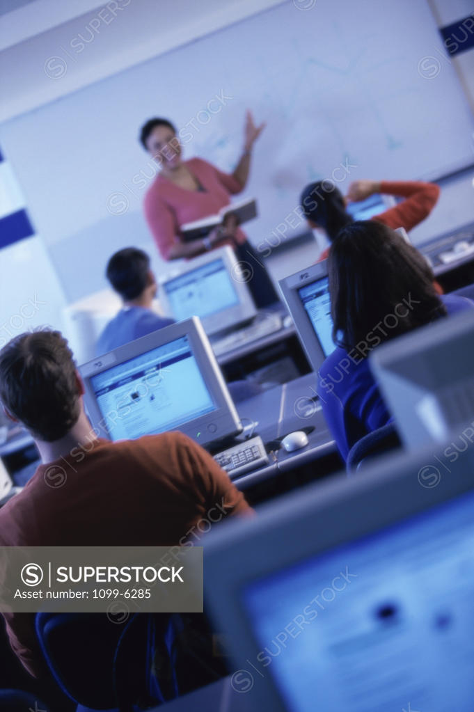 Stock Photo: 1099-6285 Female teacher teaching in a classroom