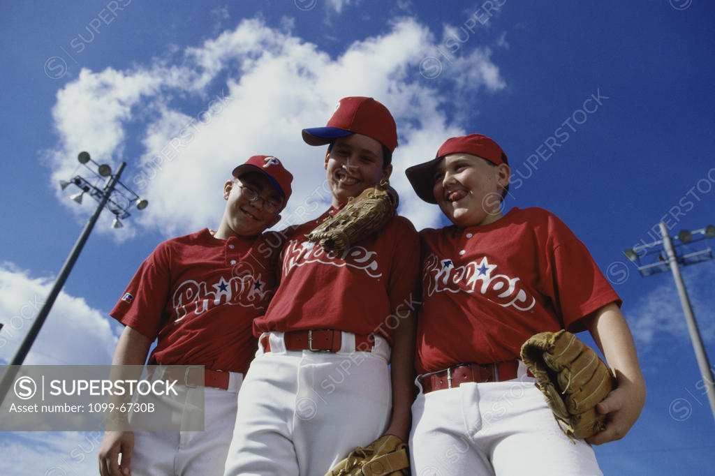 Stock Photo: 1099-6730B Low angle view of three boys on a baseball team