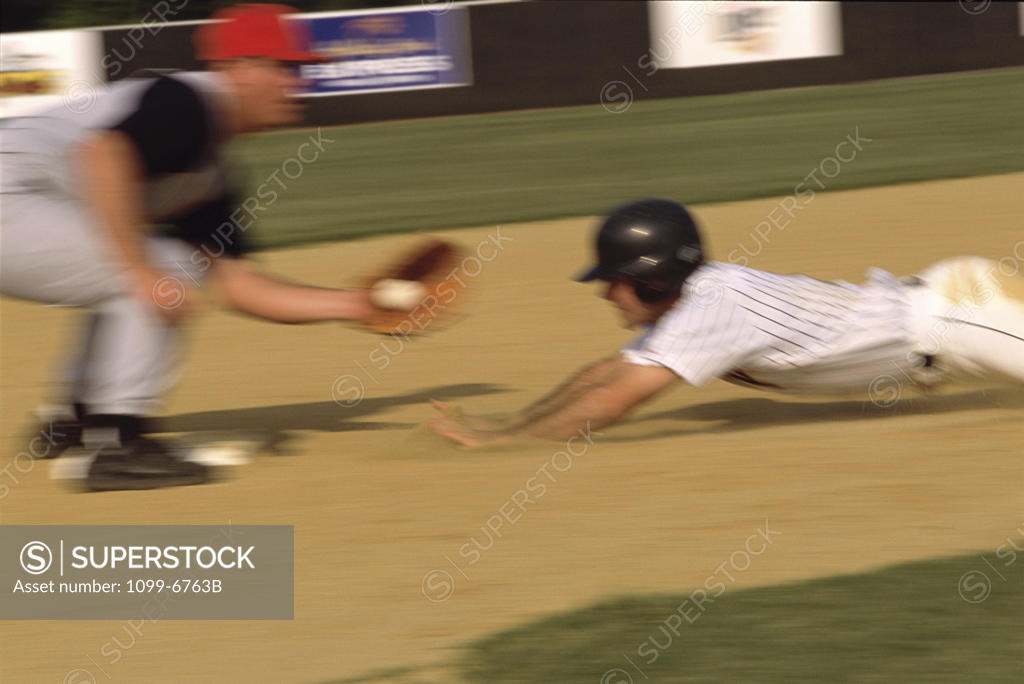 Stock Photo: 1099-6763B Baseball player sliding into a base