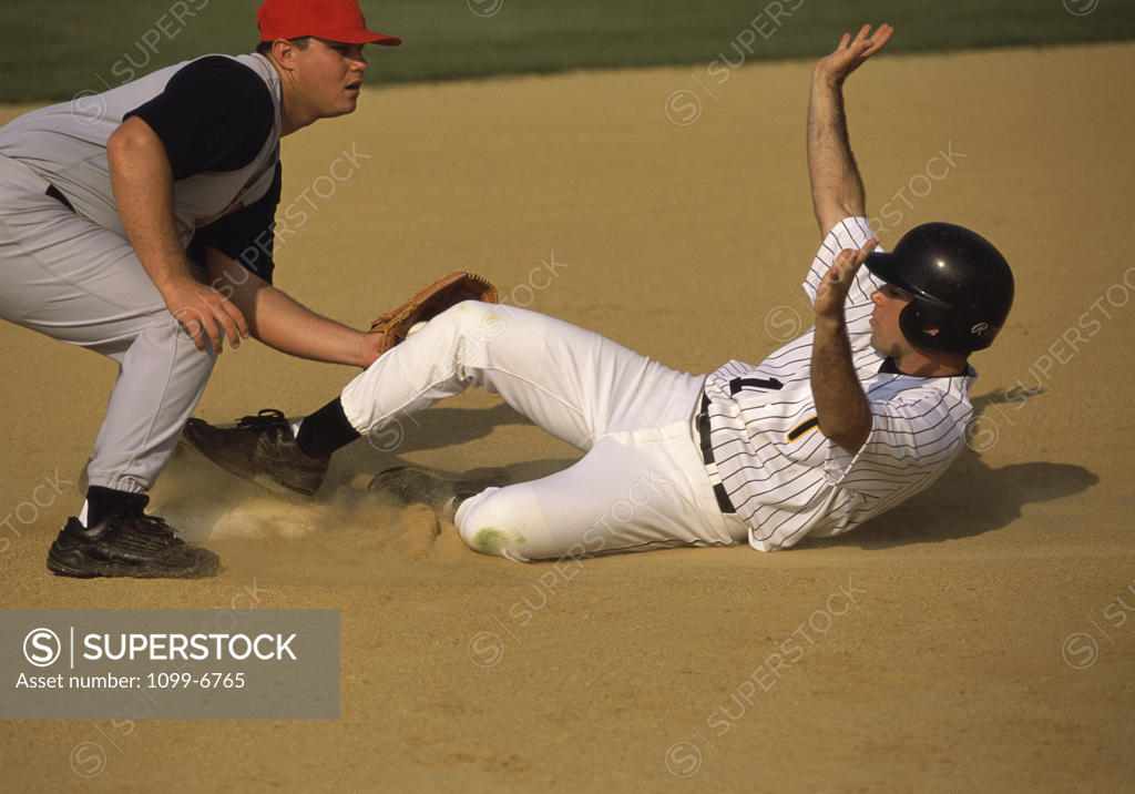 Stock Photo: 1099-6765 Baseball player sliding into a base