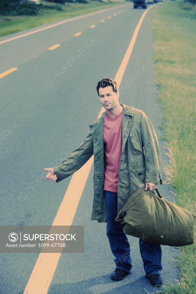 Stock Photo: 1099-6778B Young man hitchhiking