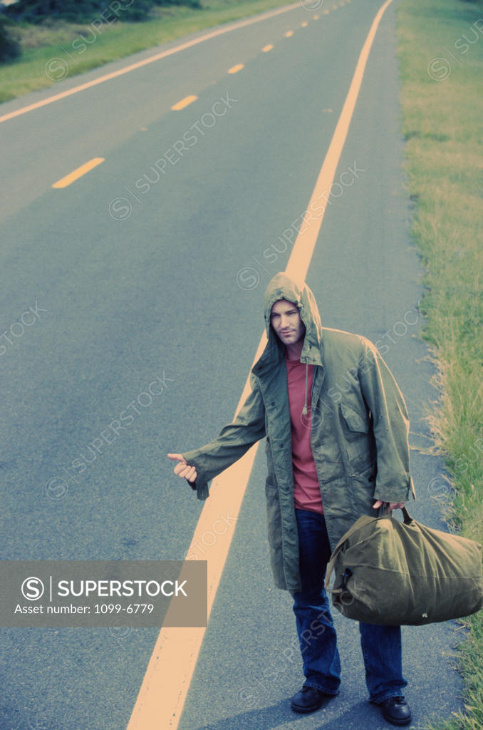 Stock Photo: 1099-6779 Young man hitchhiking