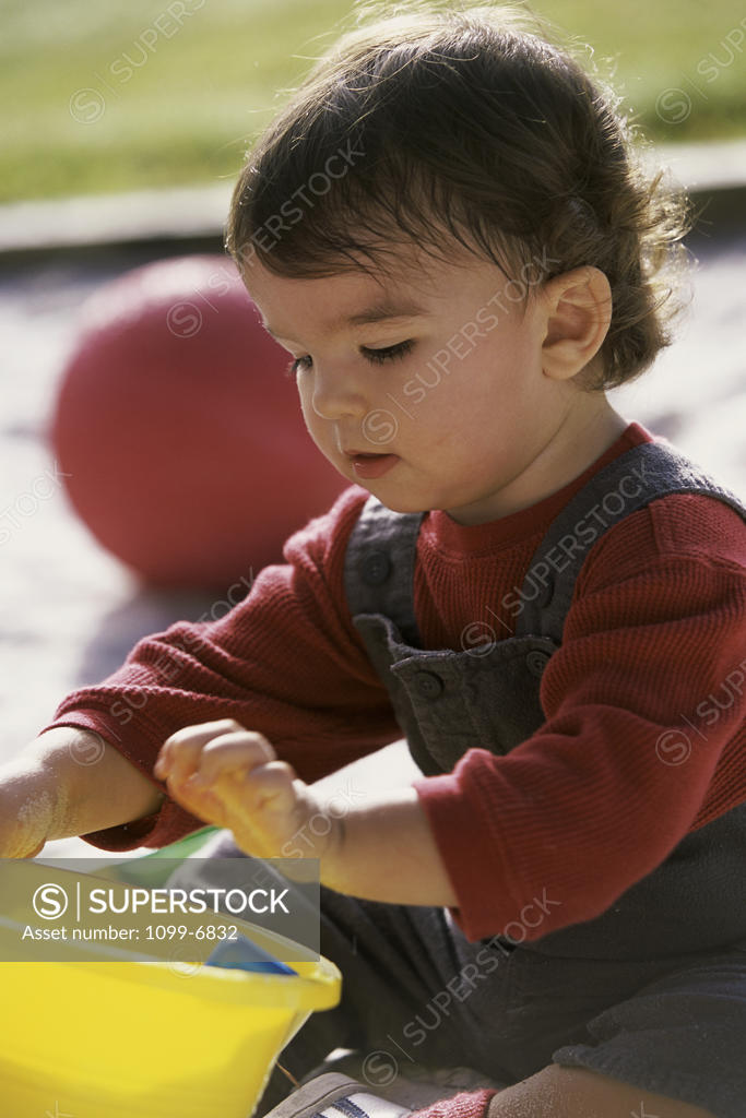 Stock Photo: 1099-6832 Boy playing with sand