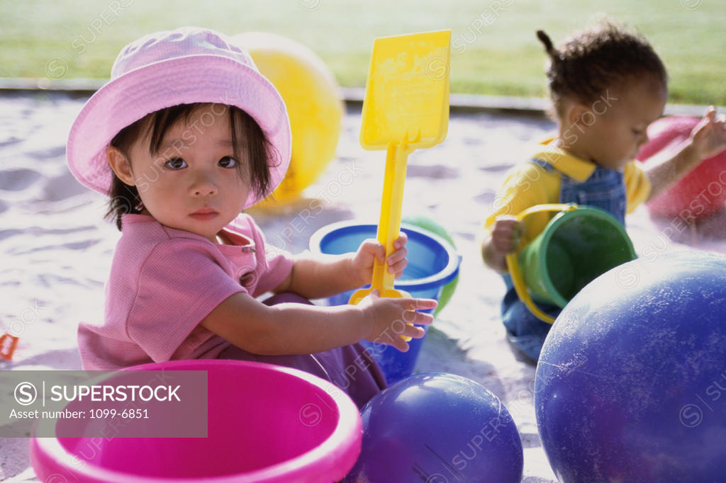 Stock Photo: 1099-6851 Portrait of a girl and a boy playing in the sand