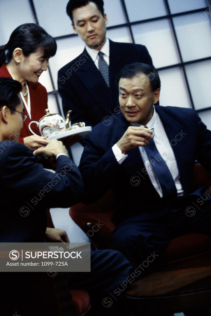 Stock Photo: 1099-725A Business executives having coffee in a meeting