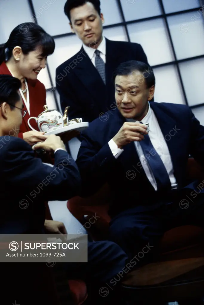 Business executives having coffee in a meeting