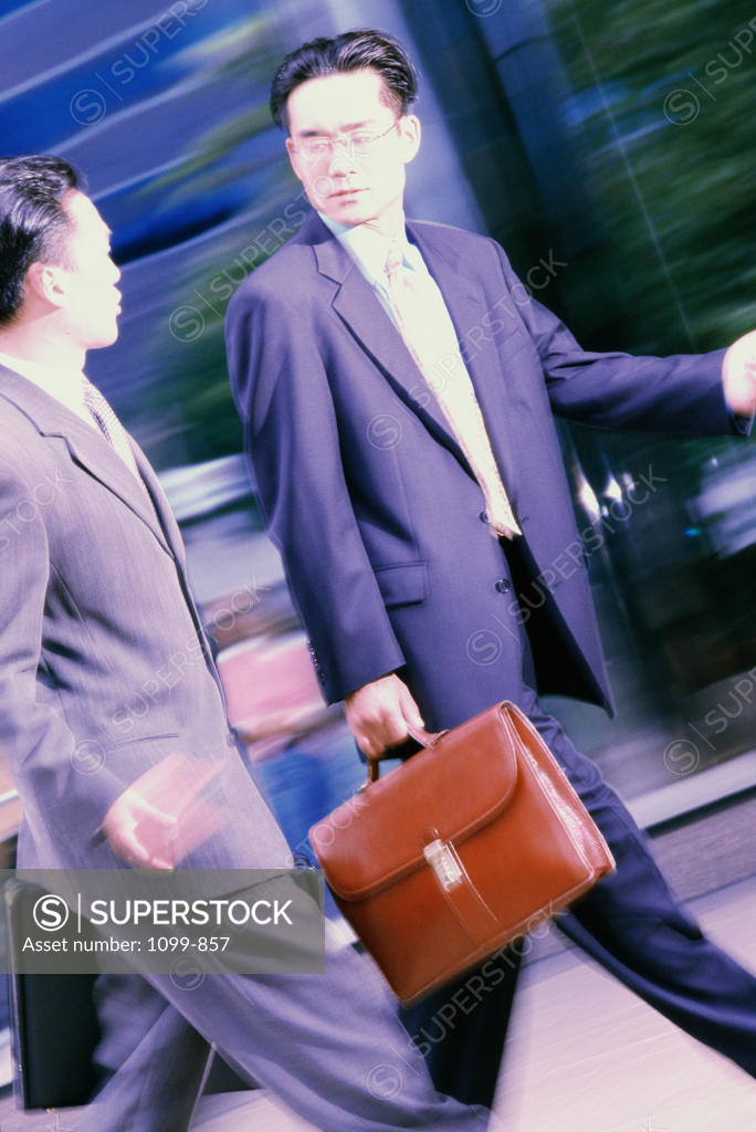 Stock Photo: 1099-857 Two businessmen walking together
