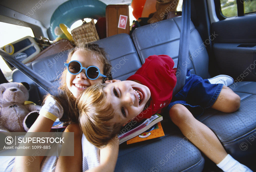 Stock Photo: 1099-885 Portrait of a girl and a boy smiling in a car