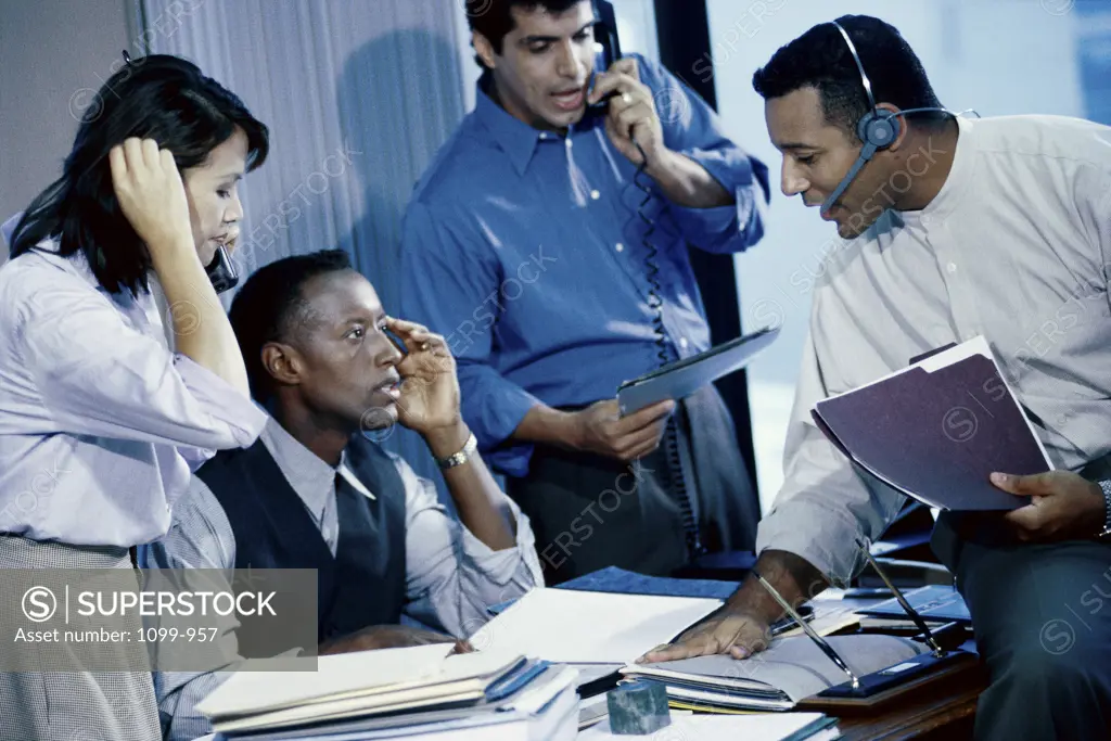 Businesswoman with three businessmen in an office