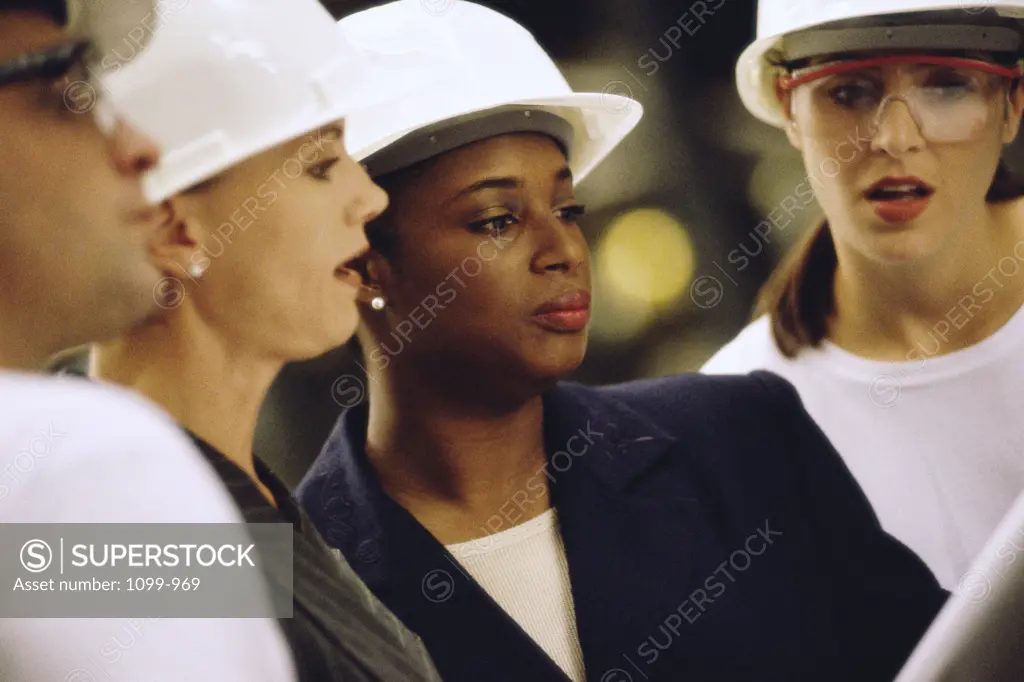 Group of construction workers looking at blueprints