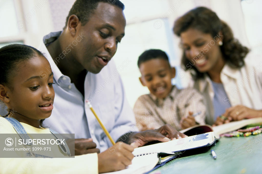 Stock Photo: 1099-971 Parents helping their son and daughter with their homework
