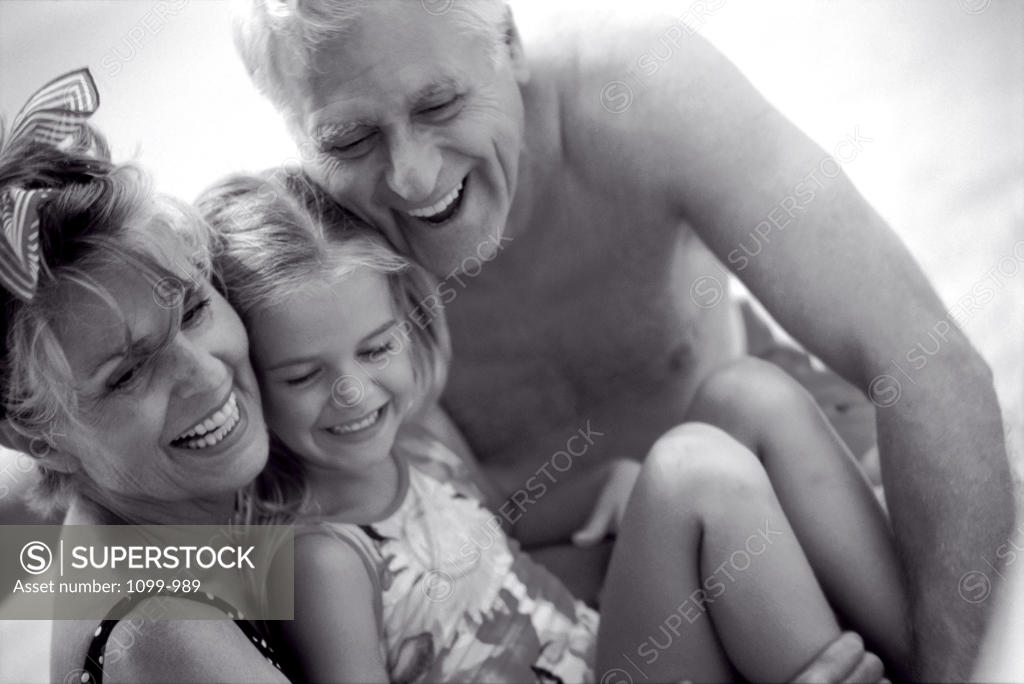 Stock Photo: 1099-989 Grandparents with their granddaughter on the beach