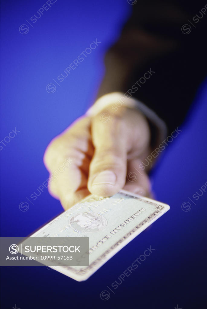 Stock Photo: 1099R-5716B Close-up of a person's hand holding a credit card
