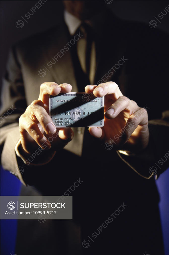 Stock Photo: 1099R-5717 Person's hands holding a credit card
