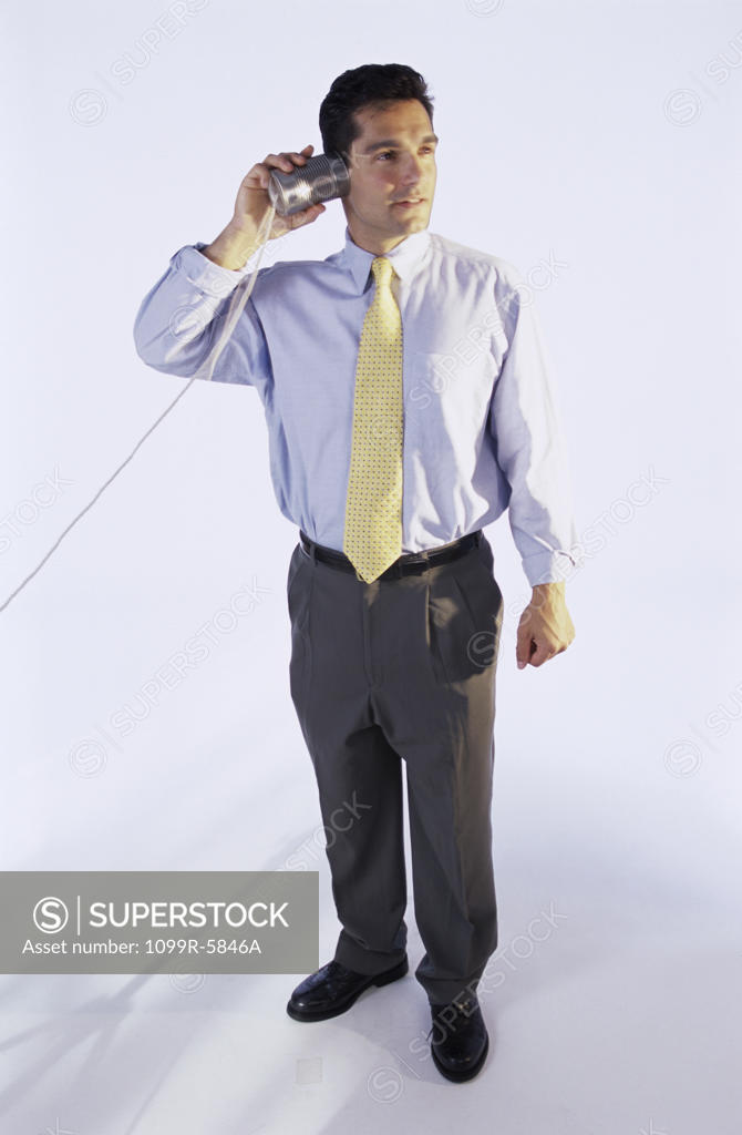 Stock Photo: 1099R-5846A Man listening with a tin can and a string