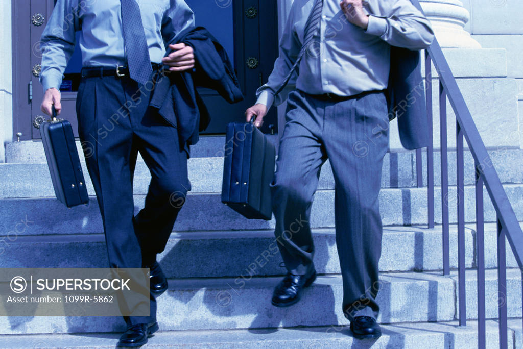 Stock Photo: 1099R-5862 Low section view of two businessmen walking down stairs
