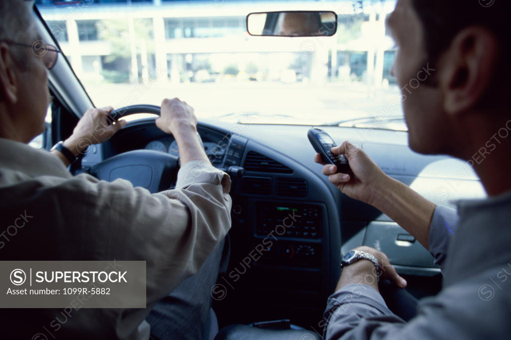 Stock Photo: 1099R-5882 Rear view of business executives sitting in a car
