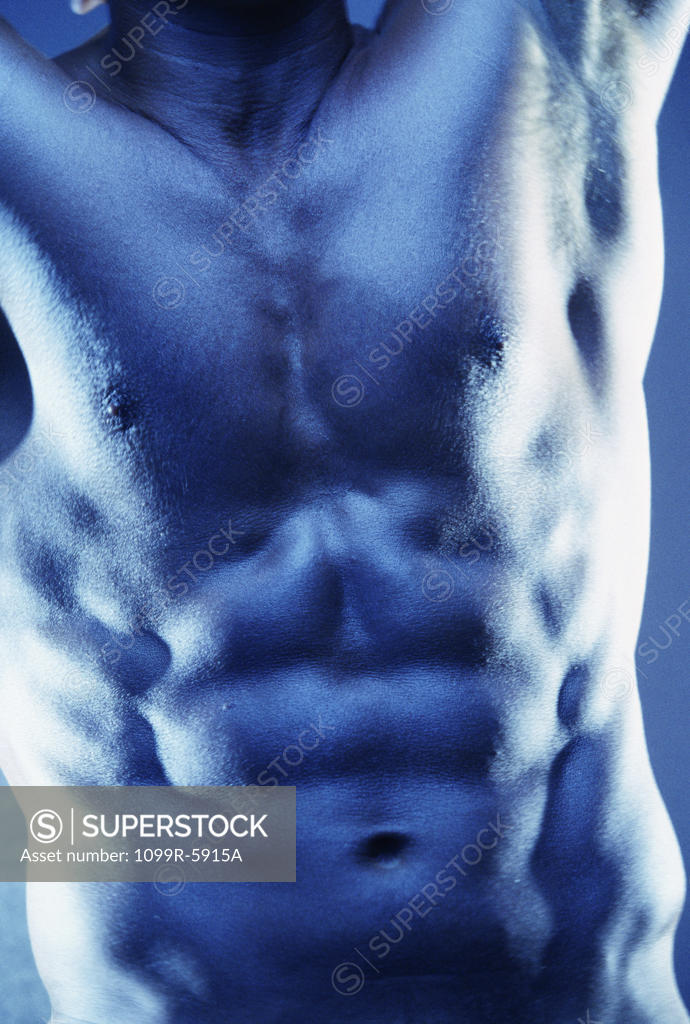 Stock Photo: 1099R-5915A Mid section view of a young man flexing his muscles