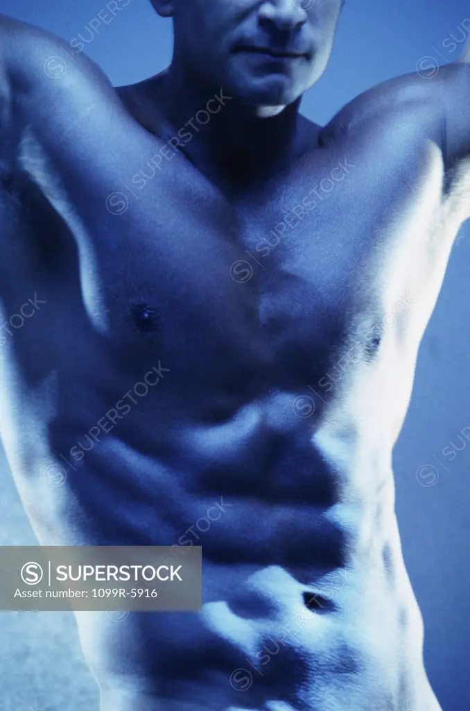 Mid section view of a young man flexing his muscles
