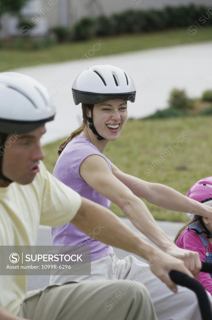 Stock Photo: 1099R-6296 Side profile of a young couple cycling