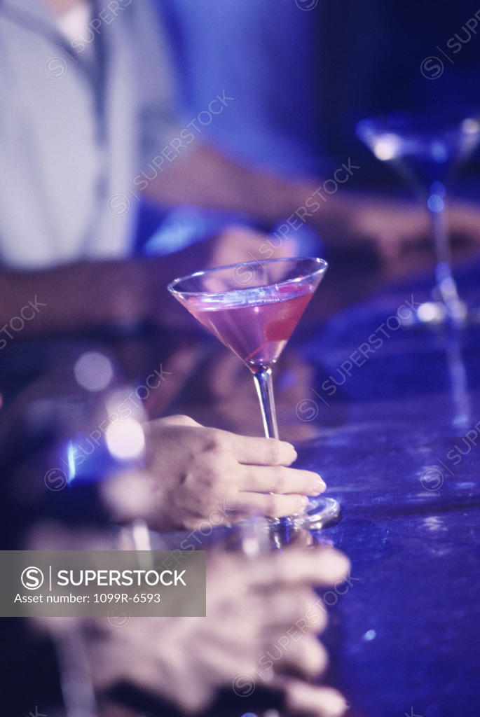 Stock Photo: 1099R-6593 Person holding a martini glass