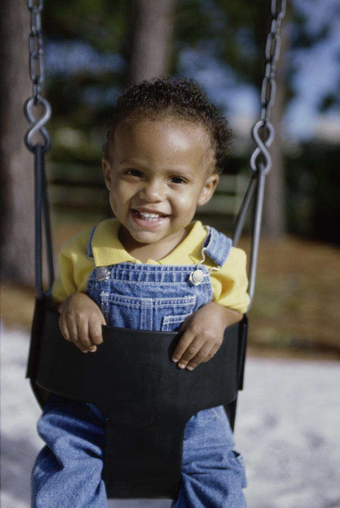 Portrait of a boy sitting on a swing