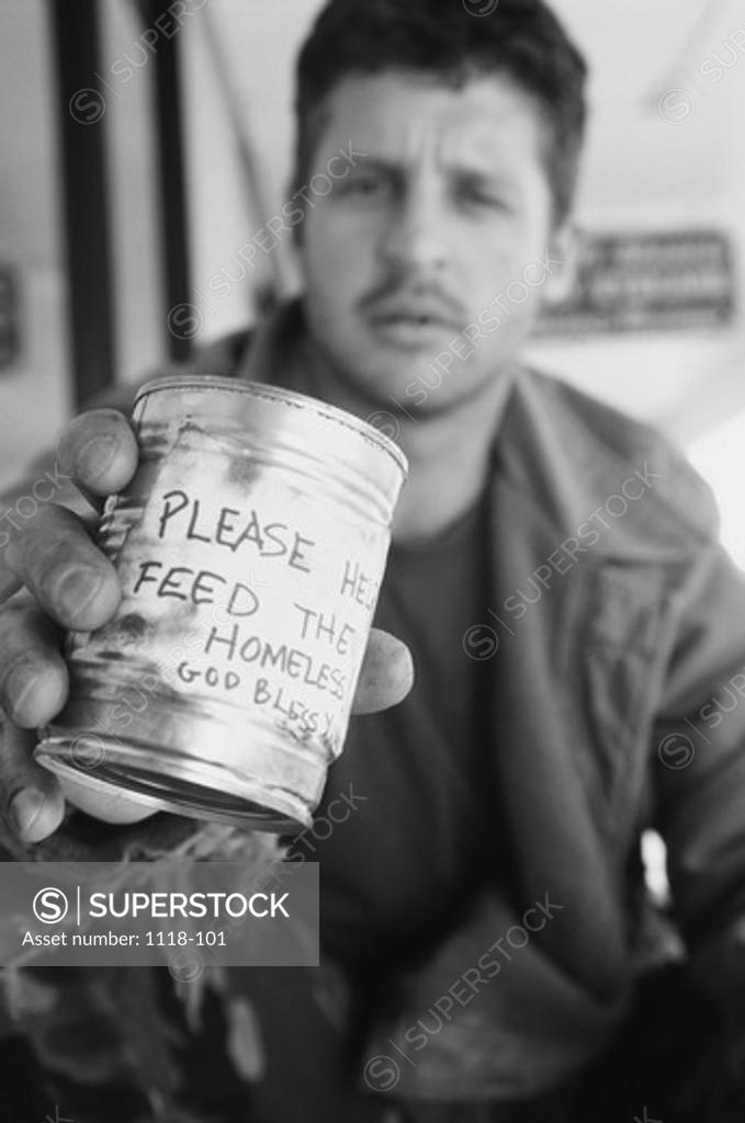 Stock Photo: 1118-101 Mid adult man on the street holding a tin can