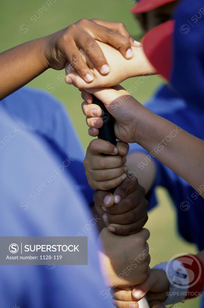 Stock Photo: 1128-119 Kids hands on bat to determine who is up first in baseball