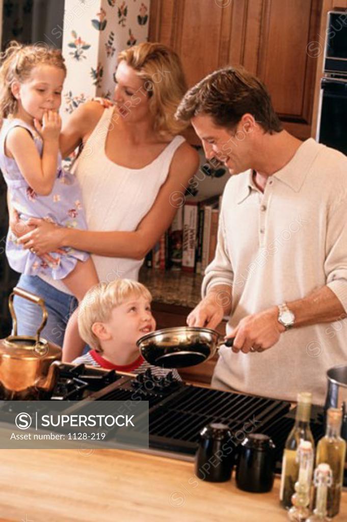 Stock Photo: 1128-219 Mid adult couple with their son and daughter in a kitchen