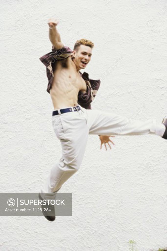 Stock Photo: 1128-264 Young man jumping in mid air