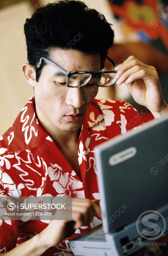 Stock Photo: 1128-341 Close-up of a young man in front of a laptop