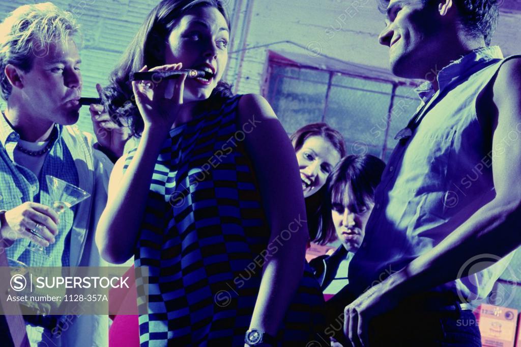 Stock Photo: 1128-357A Low angle view of a group of teenagers smoking cigars