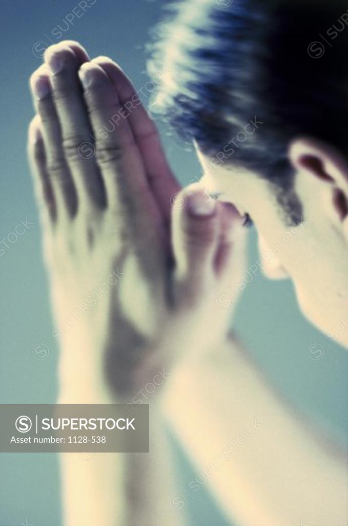 Stock Photo: 1128-538 Side profile of a young man praying