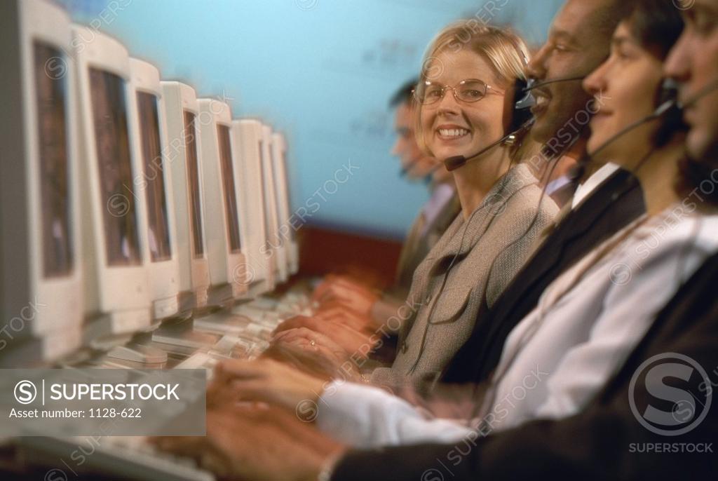 Stock Photo: 1128-622 Side profile of a group of business executives wearing headsets