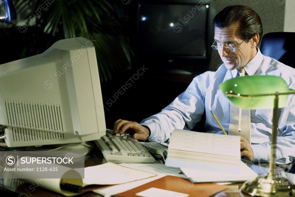 Stock Photo: 1128-635 Businessman using a computer