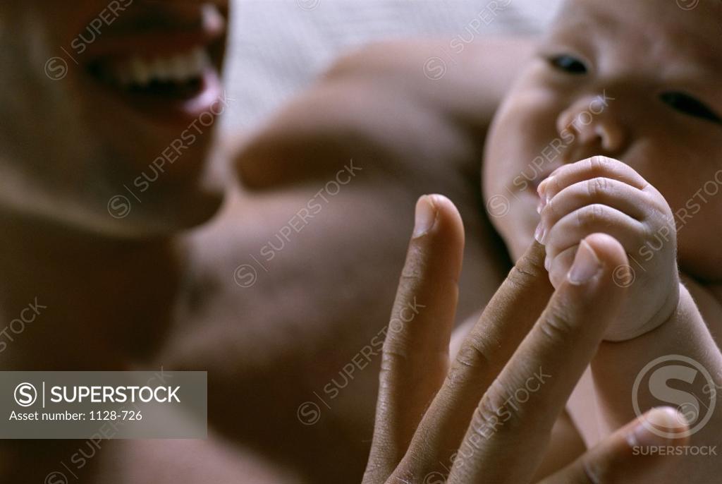 Stock Photo: 1128-726 Close-up of a father playing with his baby boy