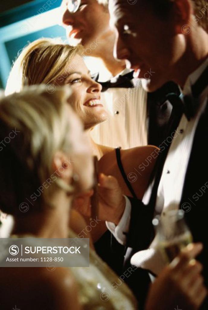 Stock Photo: 1128-850 Mid adult couple talking to each other at a party